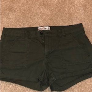 A pair of army green shorts.
